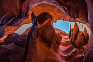 Looking up through Antelope Canyon reveals a slice of blue sky