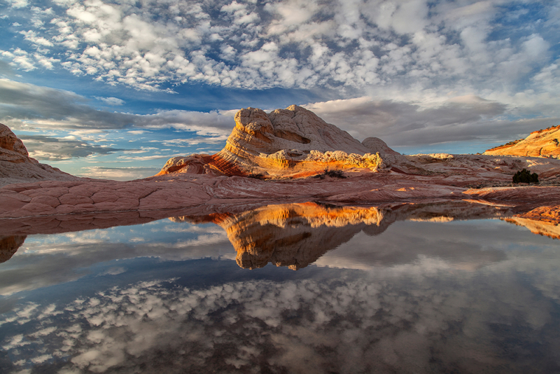 sandstone formation reflected in a still pool