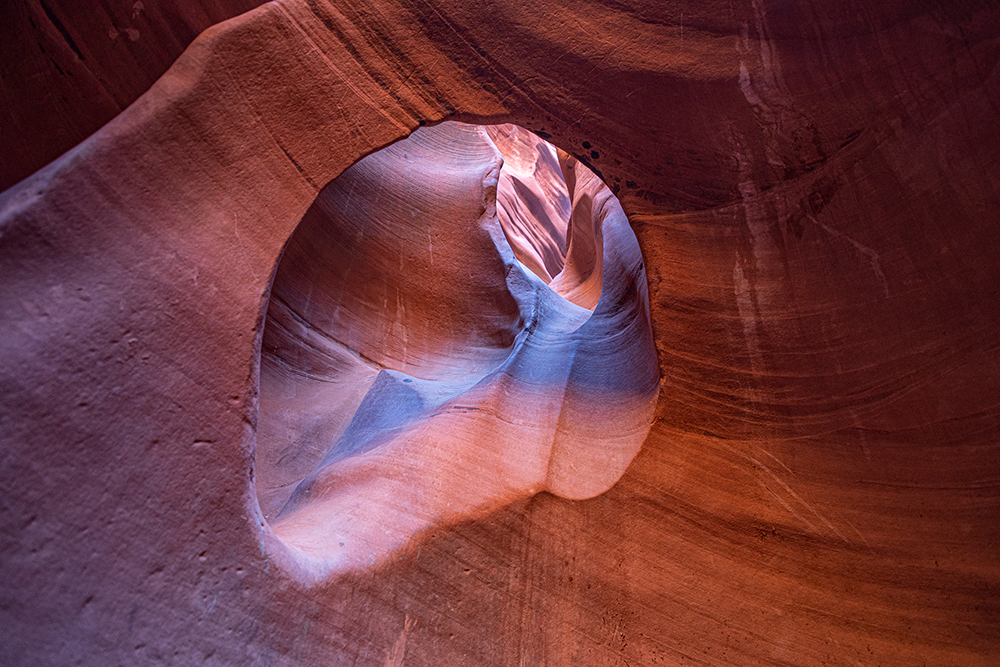 looking through an erosion window from one part of a slot canyon to another